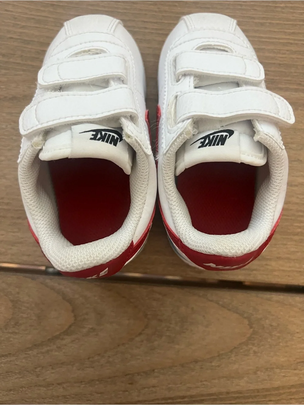 Nike Kids White Sneakers with Red Swoosh and Blue Sole Accent
